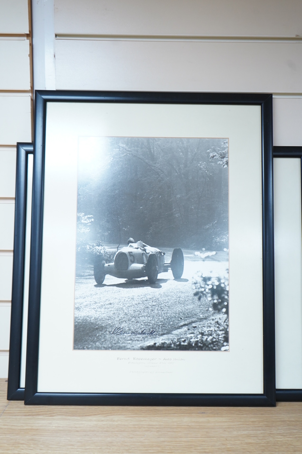 Three 1930s Donington Grand Prix motor racing black and white photographs by Klemantaski, an Auto Union driven by Tazio Nuvolari, an Auto Union driven by Bernd Rosemeyer, both 28 x 38cm, and a Mercedes Benz driven by Her